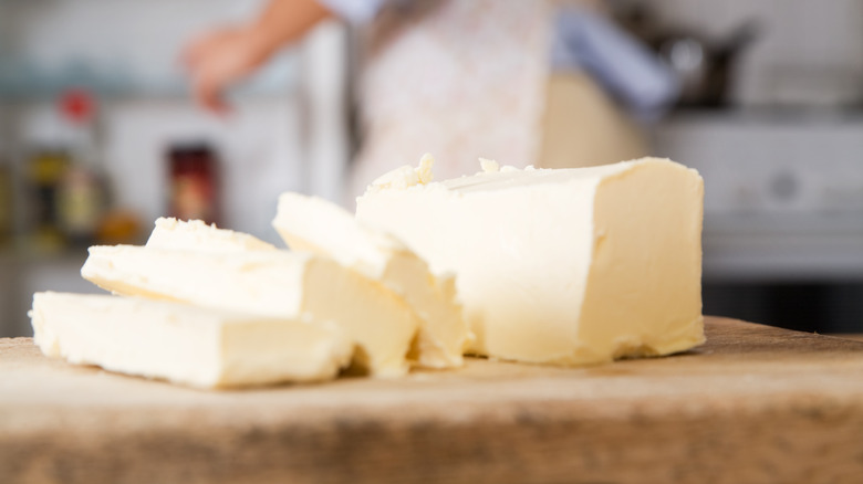 Butter in slices on chopping board 