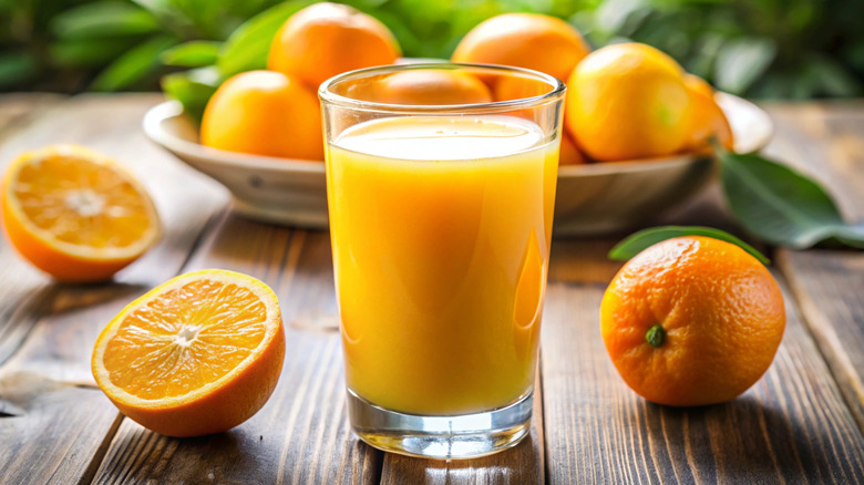 glass of orange juice on wooden table