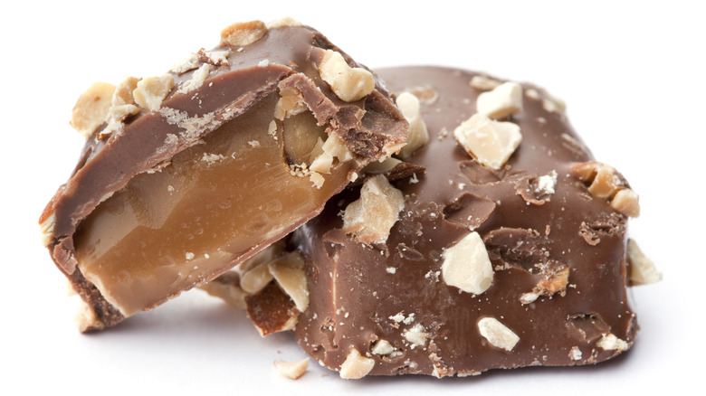 Chocolate-covered toffee on white background