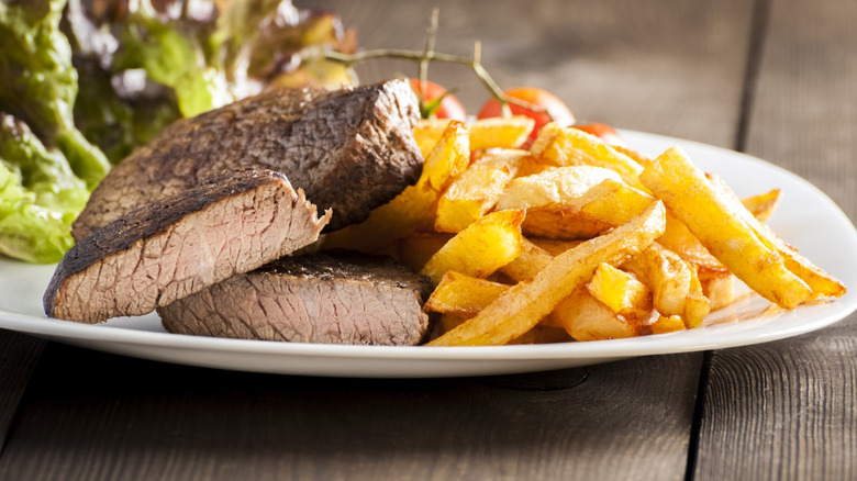 overcooked steak with French fries