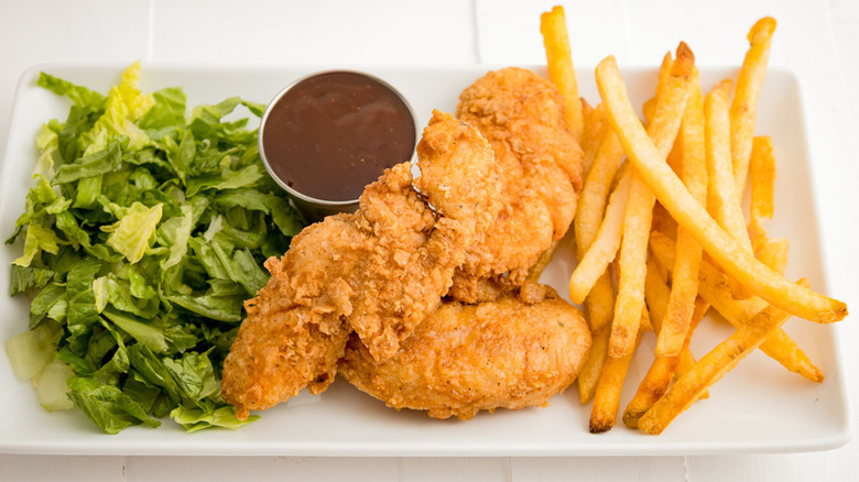 Chicken tenders and fries on plate