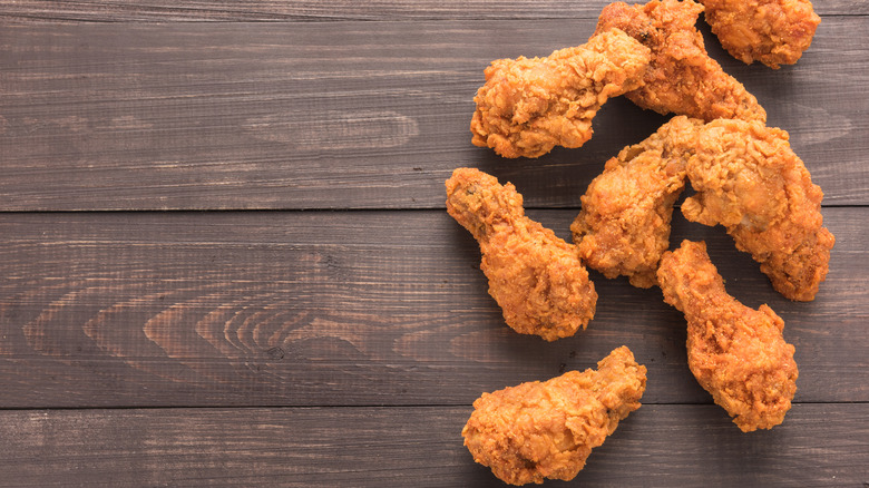 pieces of fried chicken on a wooden background