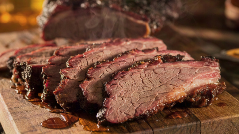 Smoking hot brisket on wooden board