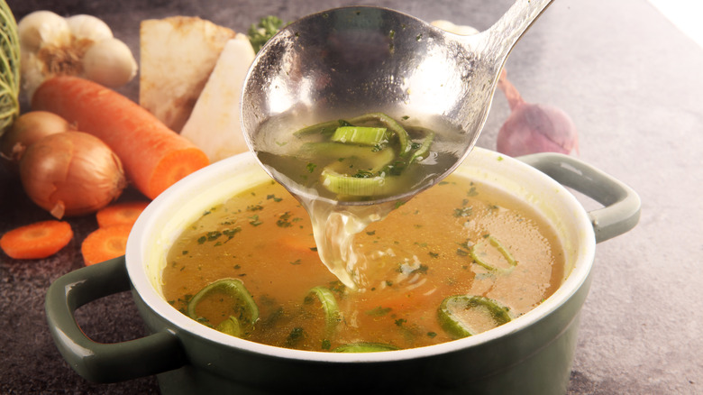 A pot of soup with a ladle