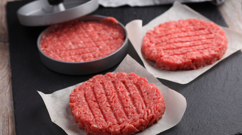 Hamburger patties in a press