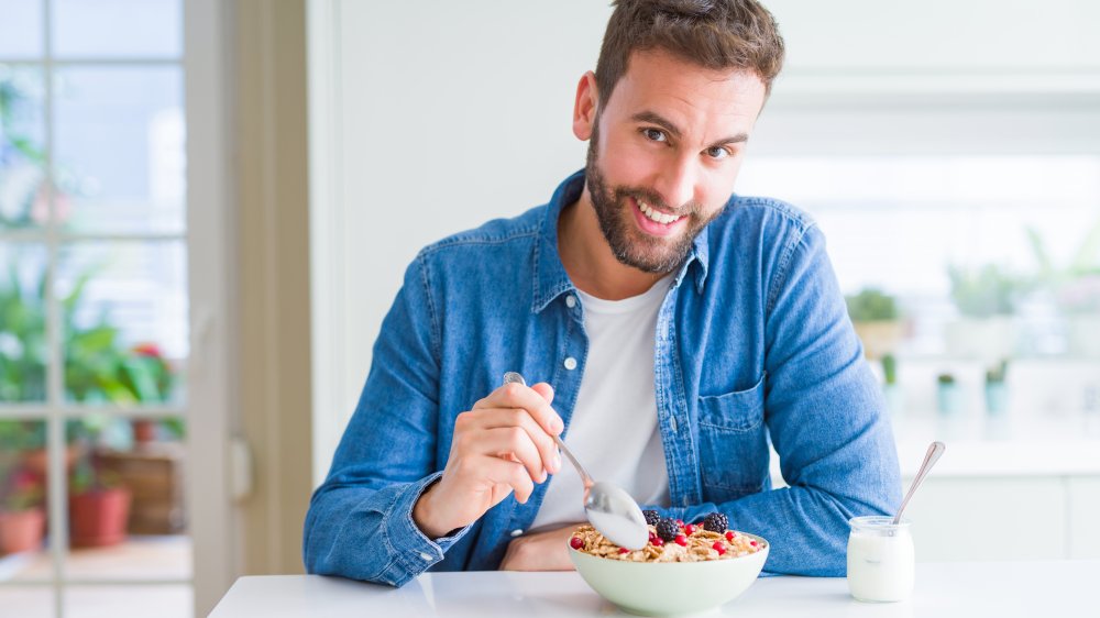 Man eating bowl of cereal