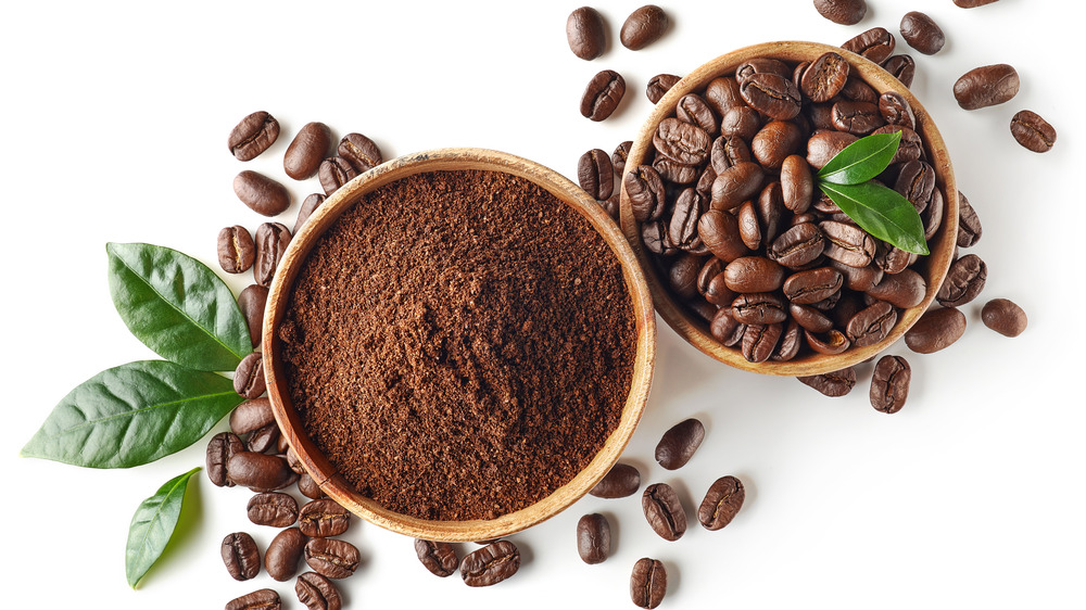 Coffee grounds in bowl with beans