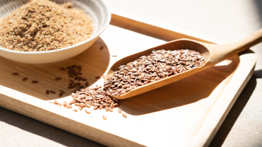 Flaxseeds on white background spelling out Flax