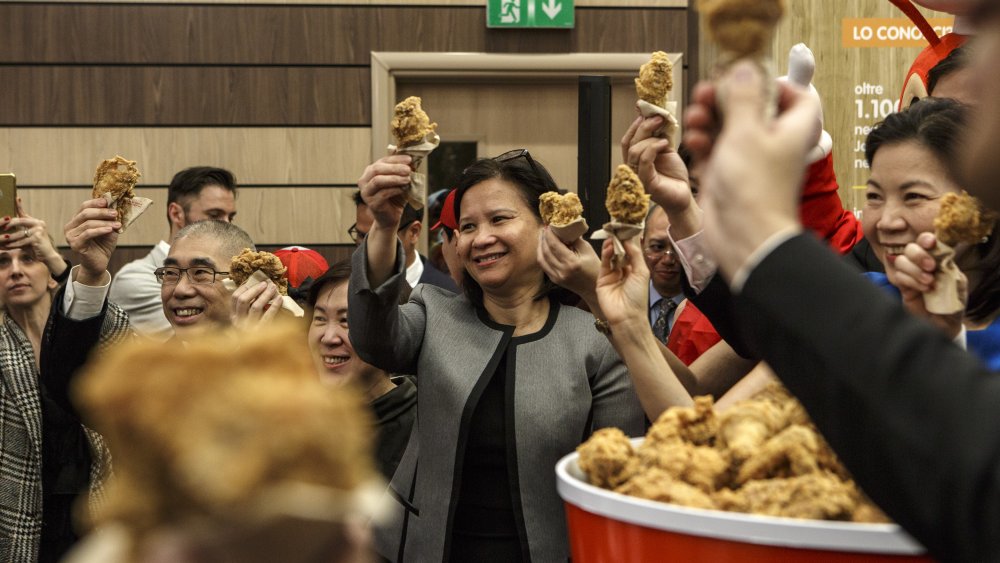 Guests toast with a piece of fried chicken during the opening of a Jollibee restaurant on April 11, 2018 in Milan, Italy. Jollibee Food Corporation, a Filipino chain of fast food restaurants and the largest Asian food services company, has chosen Milan, home of the biggest Filipino community in Europe, to open its first European branch.
