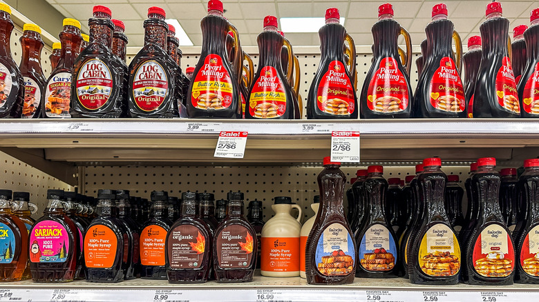 Pancake syrup and maple syrup displayed on grocery shelf