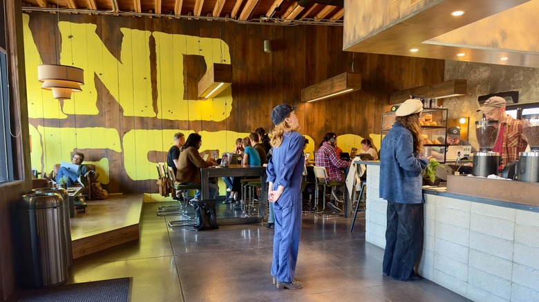 Customers at the counter and tables of And Destroy coffee shop
