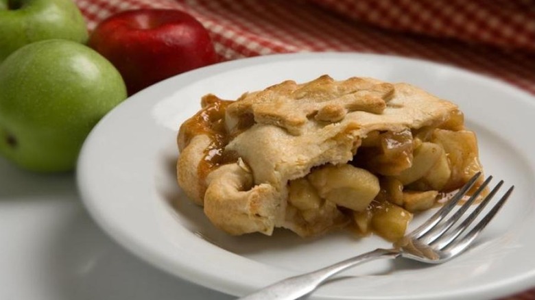 slice of classic apple pie on white plate
