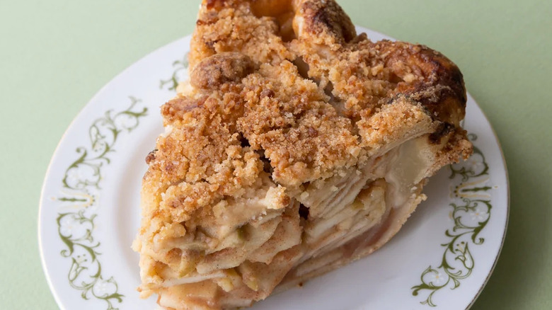 apple crumble pie slice on white and green vintage plate