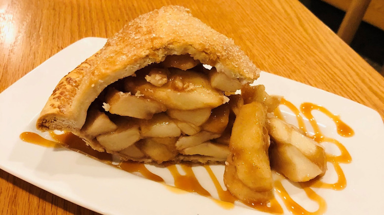 slice of homemade apple pie on rectangular white plate