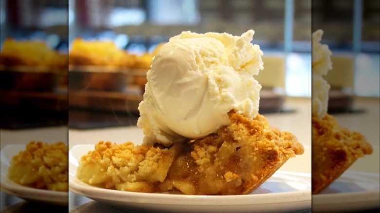 apple pie slice with big scoop of vanilla ice cream