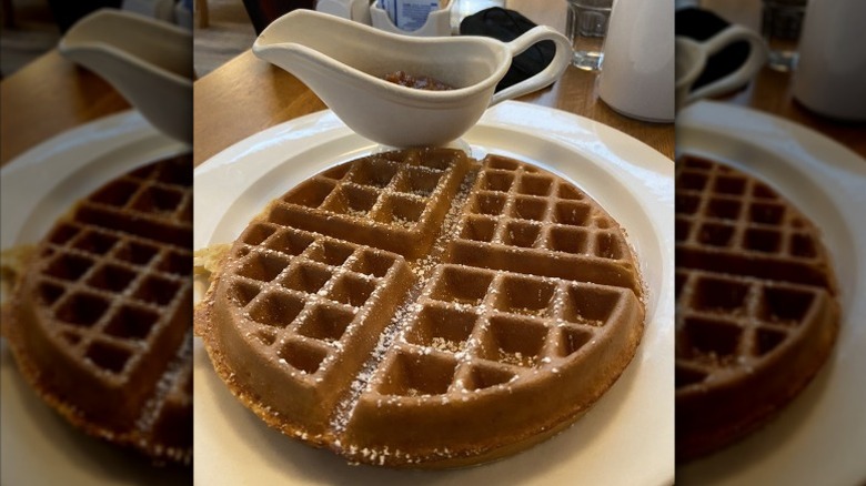 A malted waffle with maple syrup.