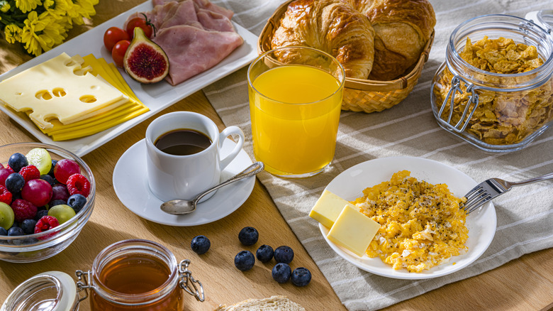 a breakfast spread including eggs, croissants, and cheese