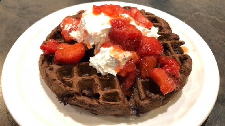 Waffle with whipped cream and strawberries.