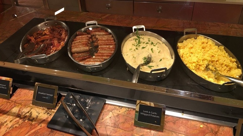 Breakfast sausages and whipped potatoes on brunch buffet.