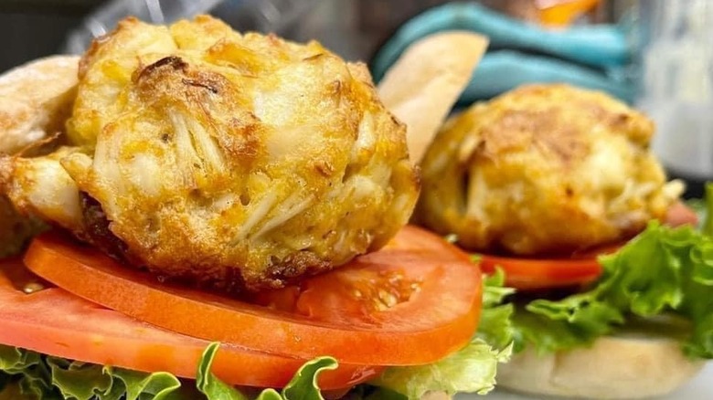 Crab cakes on top of tomato and lettuce