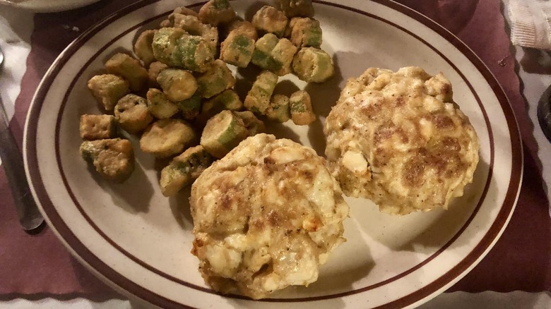 Crab cake platter with two crab cakes and fried vegetables