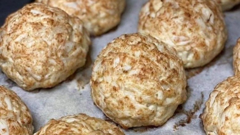 Multiple crab cakes on a baking sheet