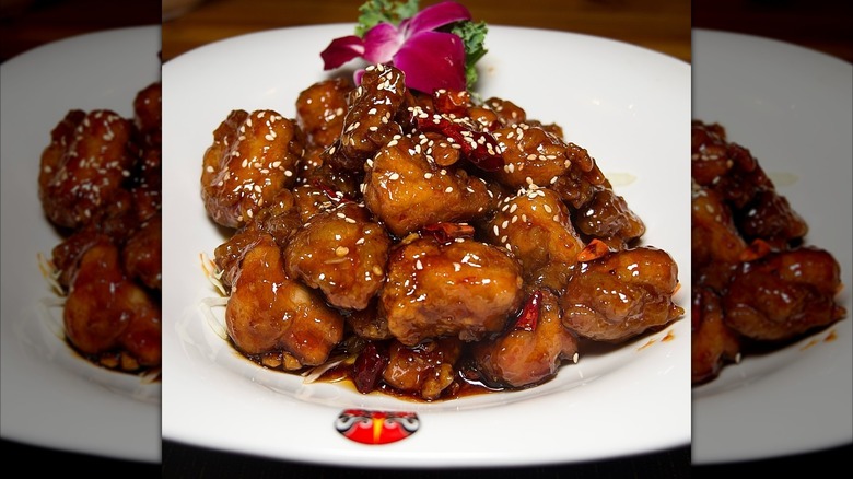 Chiho Bistro General Tso's chicken on white plate with sesame seed and garnishes