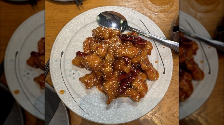 General Tso's chicken on plate with spoon at Osmanthus Dim Sum Lounge in San Francisco