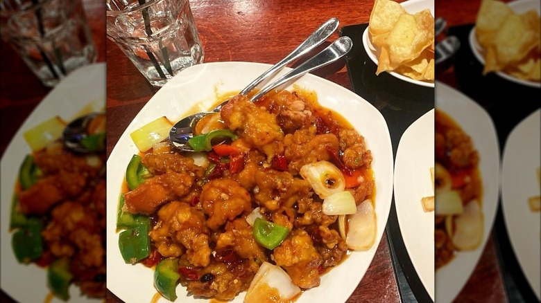 Plate with large portion of General Gau's chicken dish on table at Q Restaurant in Boston