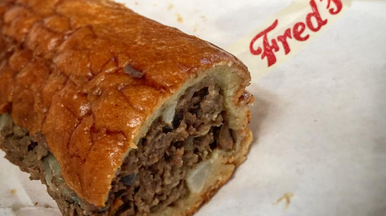 Fred's & Bread Philly cheesesteak with wrapper.