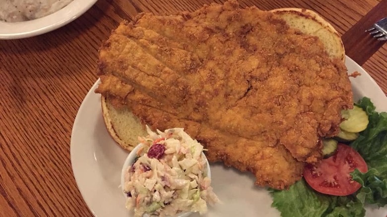 large breaded pork tenderloin served open face