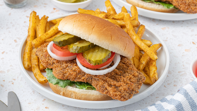 pork tenderloin on plate with fries