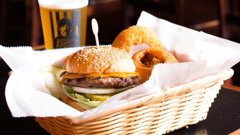 Cheeseburger with onion rings in basket