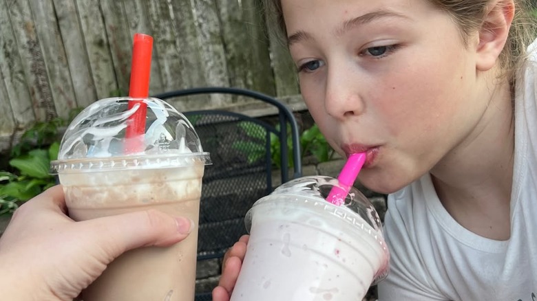 Child drinking milkshake.