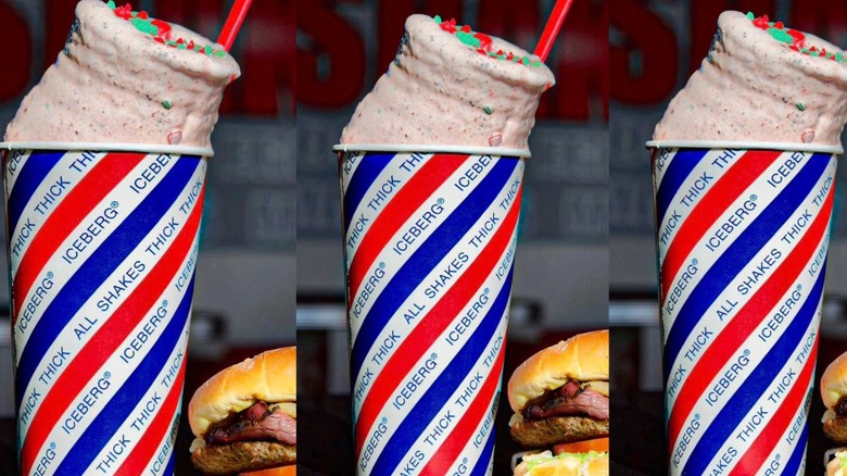 Thick milkshake in red, white, and blue Iceberg cup with red plastic spoon.