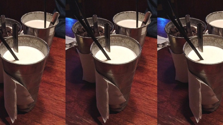 Milkshakes in metal cups.