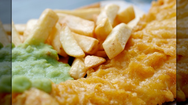Plated fish and chips with mushy peas at Ainsworth's Fish & Chips in Caernarfon, Gwynedd