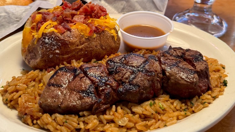 Texas Roadhouse steak and baked potato on plate