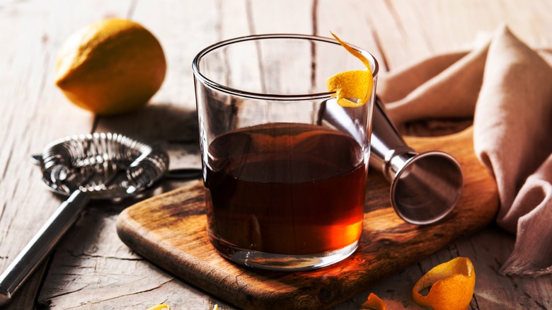 Sazerac cocktail on wooden board