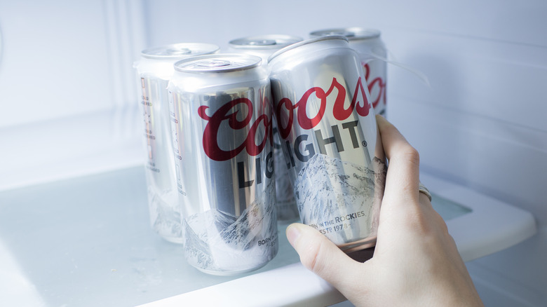 Person taking Coors Light can from fridge