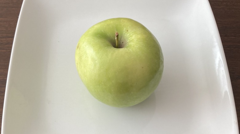 green Granny Smith apple on plate