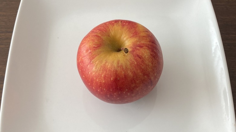 Envy apple at center of plate