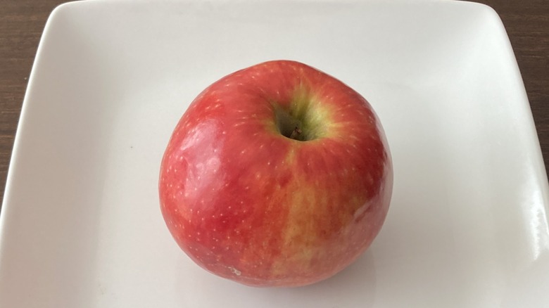 Pink Lady apple on white plate
