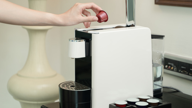 woman using coffeemaker pod