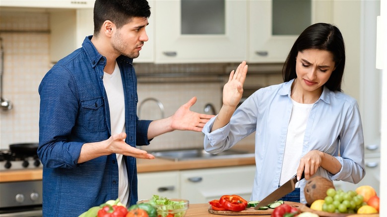 Man and woman arguing in kitchen 