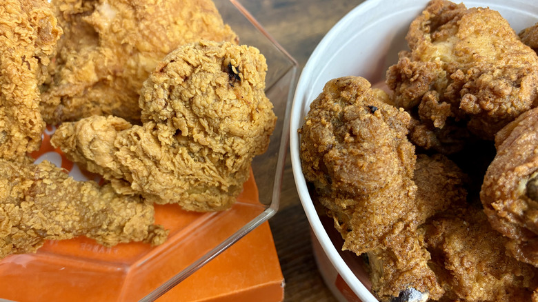 Orders of Popeyes Signature Chicken and KFC Original Recipe fried chicken next to each other for comparison