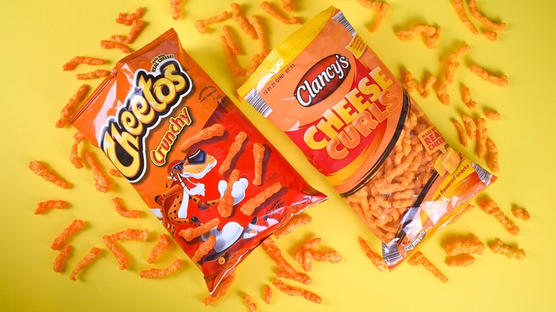 Bags of Cheetos and Aldi brand Clancy's Cheese Curls on a yellow background