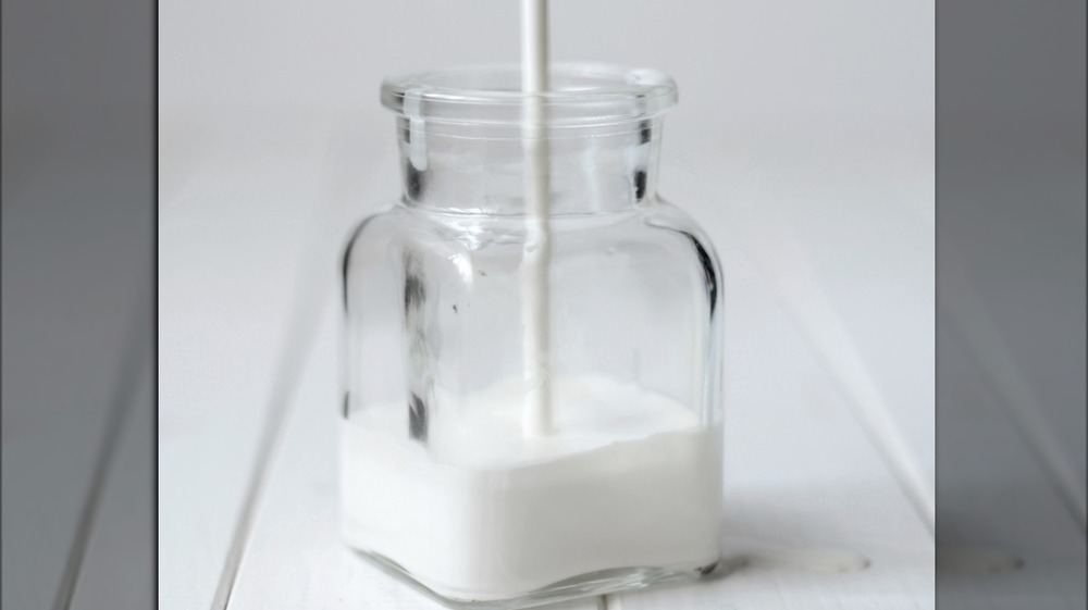 Cream being poured into a jar
