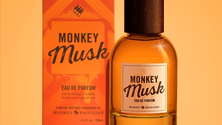 A bottle of perfume next to a bottle of Monkey Shoulder