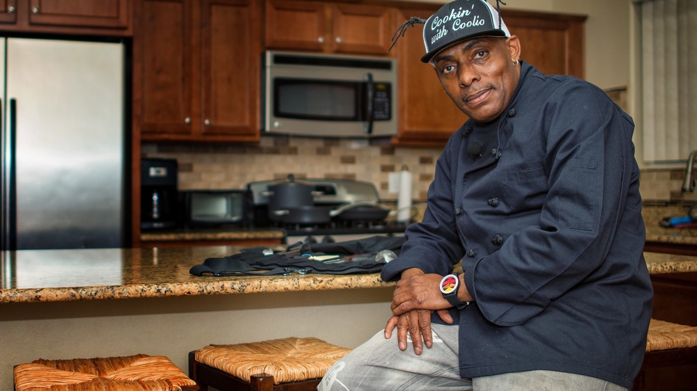 Coolio posing in a kitchen